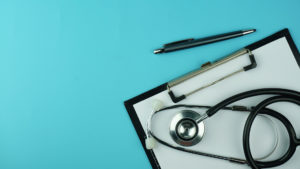 stethoscope with clipboard and pen