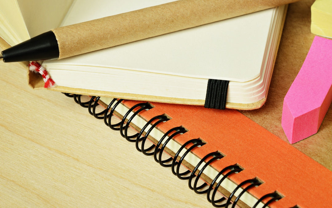 notebook and pen with sticky notes