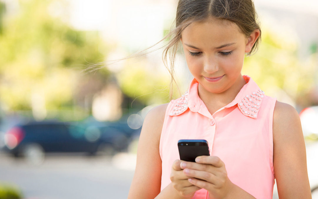 young girl texting on smartphone