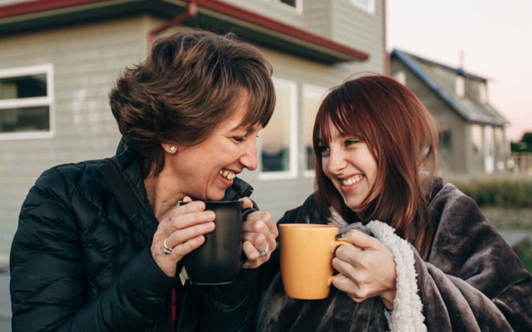 mother and teen daughters with coffee mugs