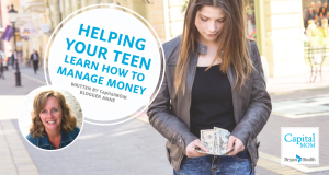 Young teen girl looking at money in hands