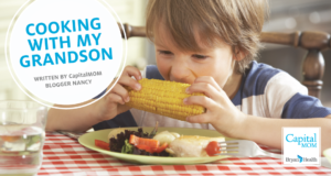 Young boy eating corn on the cob