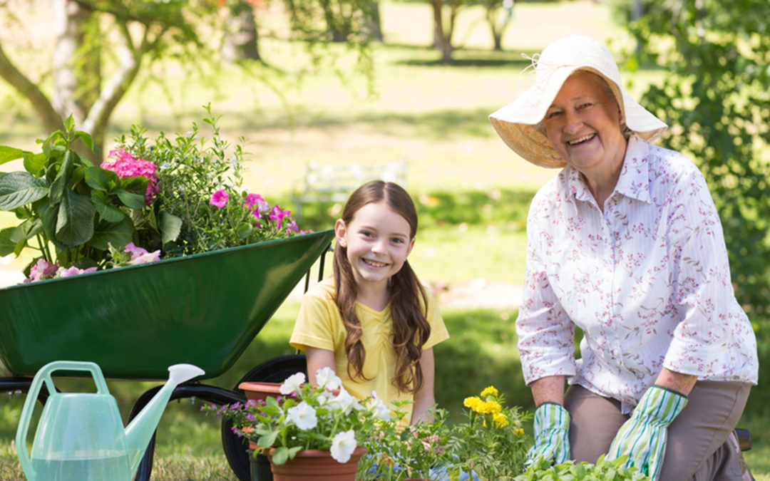 Young girl and grandma out in garden