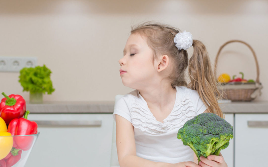 little girl refusing broccoli