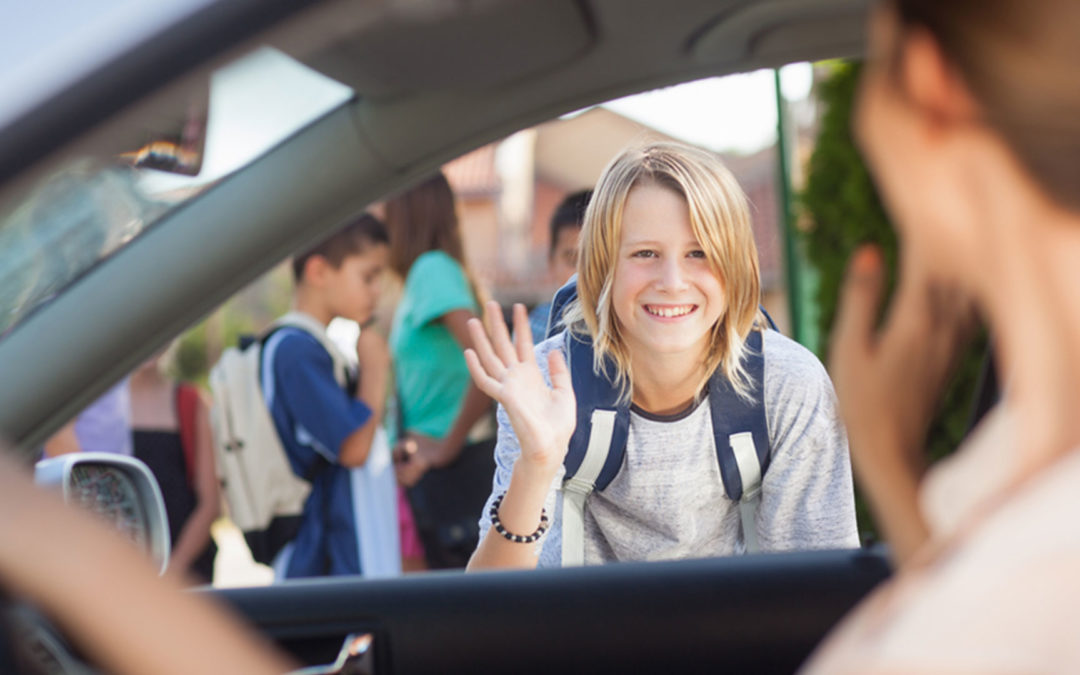 teenager waving at parent in car