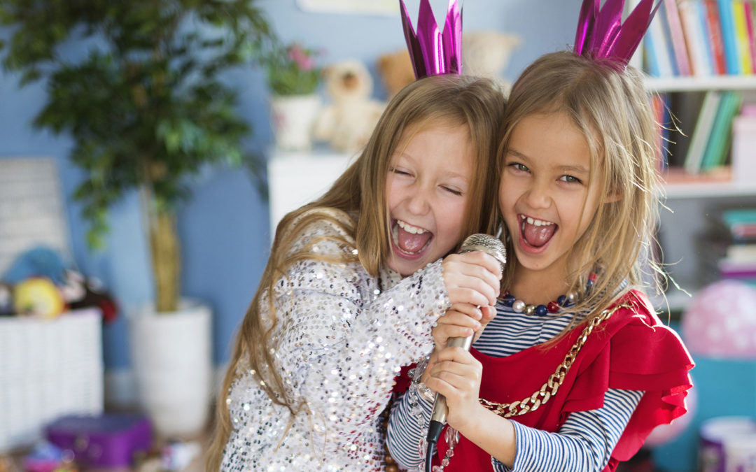 young girls dressed up in costumes singing