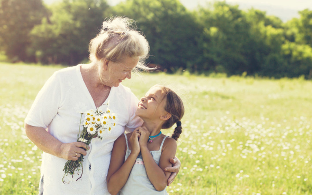 grandmother and granddaughter holding flowers
