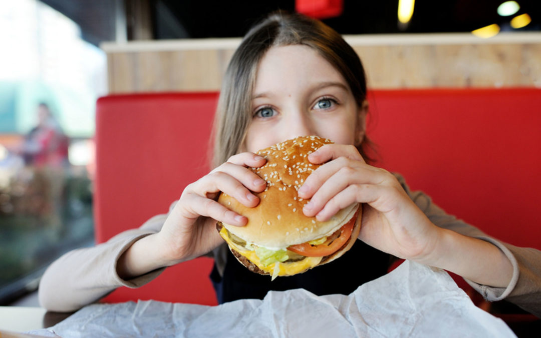 kid holding cheeseburger