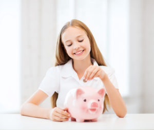 Young girl with piggy bank