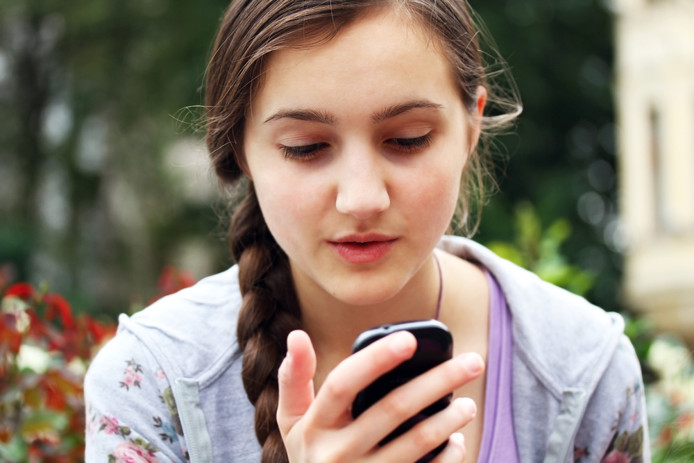 Teen girl looking at smartphone