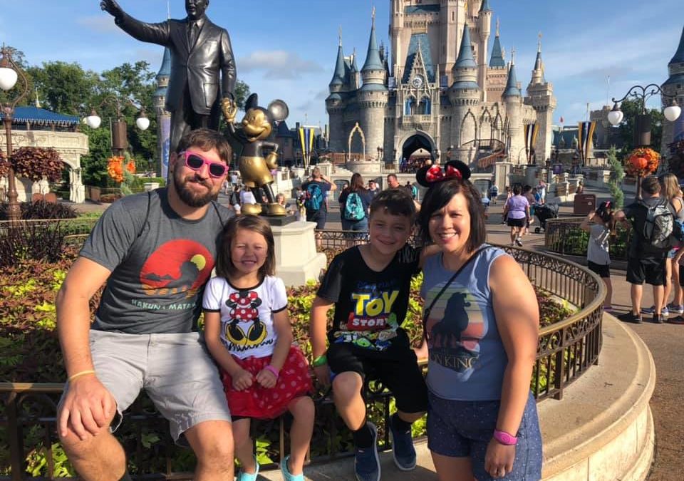 family posing for picture at disney world