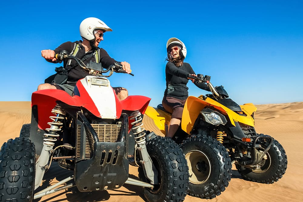 couple riding a quad runner
