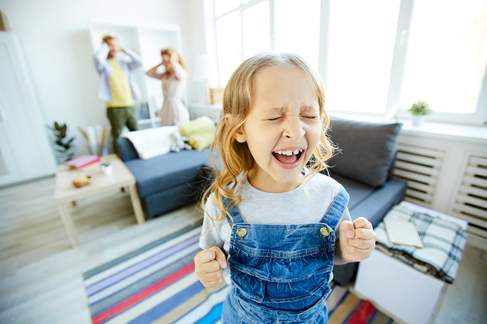 upset child and parents in living room