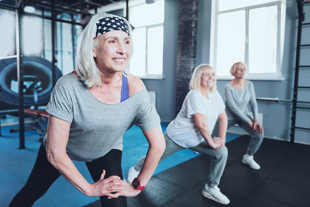 senior women stretching in gym