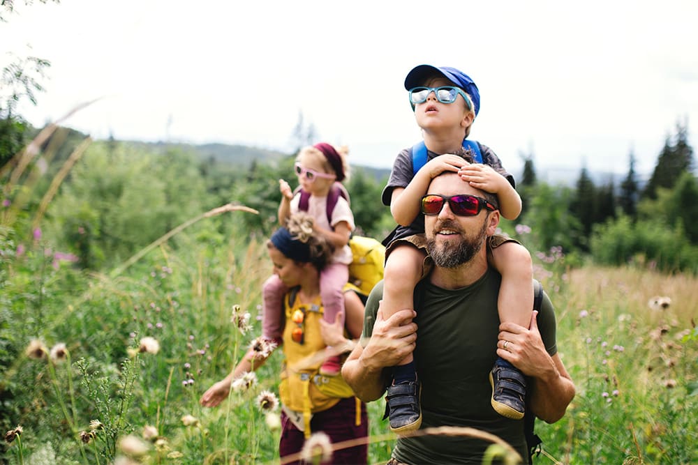 family-hikes-outdoors-wearing-eye-protection