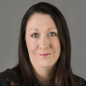 Headshot of Alicia Cruce on gray background