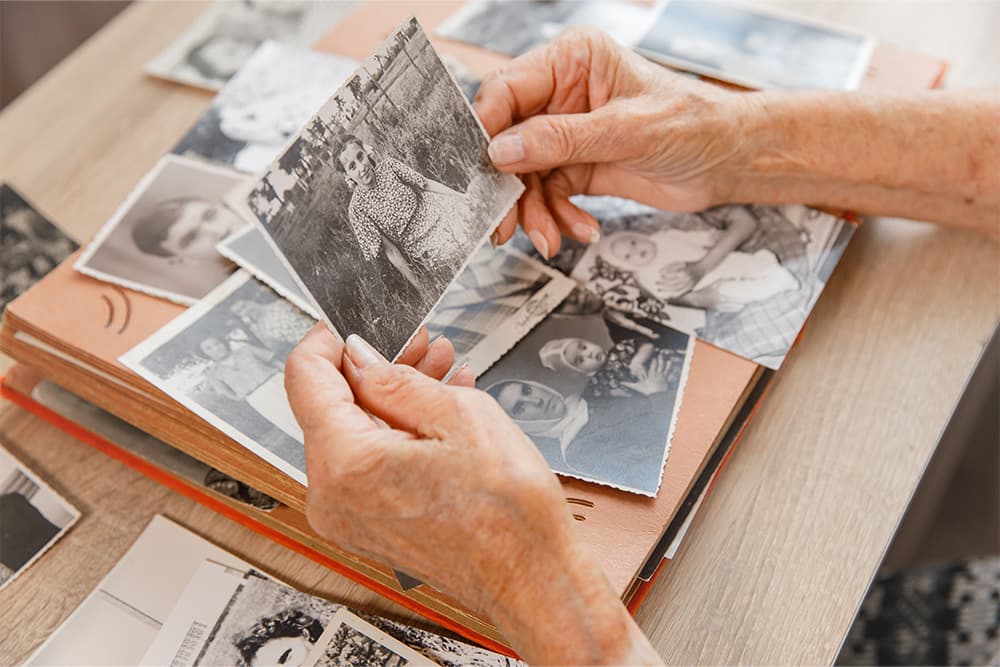 senior-looking-through-old-family-photos