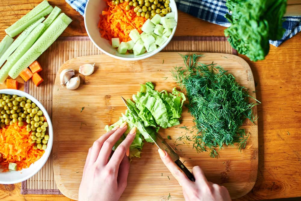 Picture of hands chopping vegetables on cutting board as featured image for Multiple Sclerosis and Dietary Changes