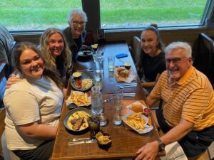Family photo of Nancy and her grandkids at a restaurant