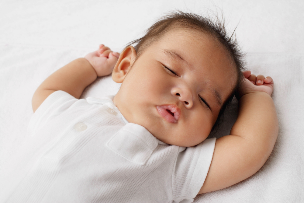 newborn baby sleeping on back