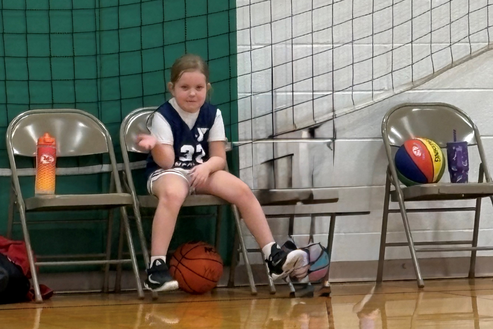 Ellen's granddaughter, Sophia, on the bench at her basketball game