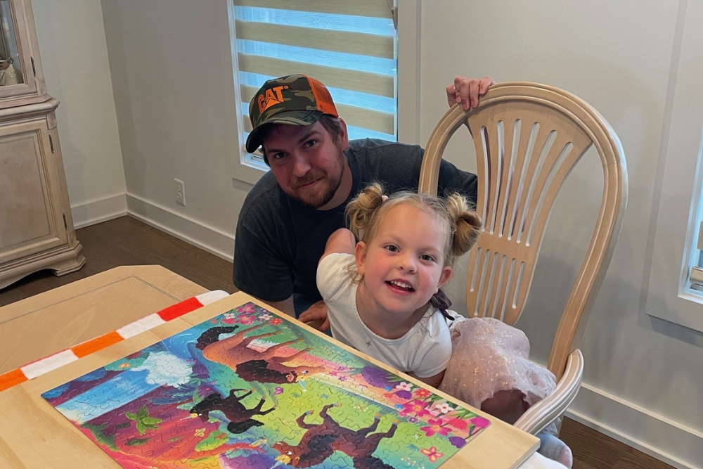 Ellen's son and granddaughter working on a puzzle