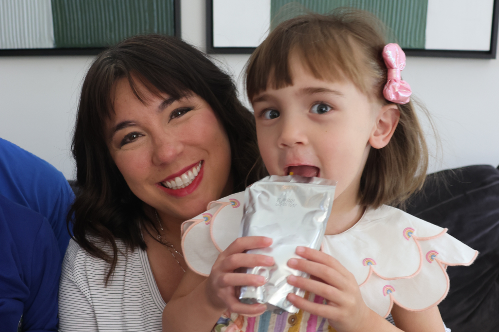 Cassidy holding her daughter, both smiling