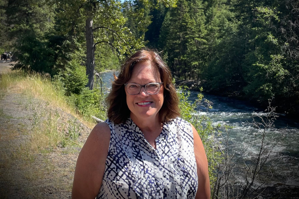 Ellen standing by a river or creek