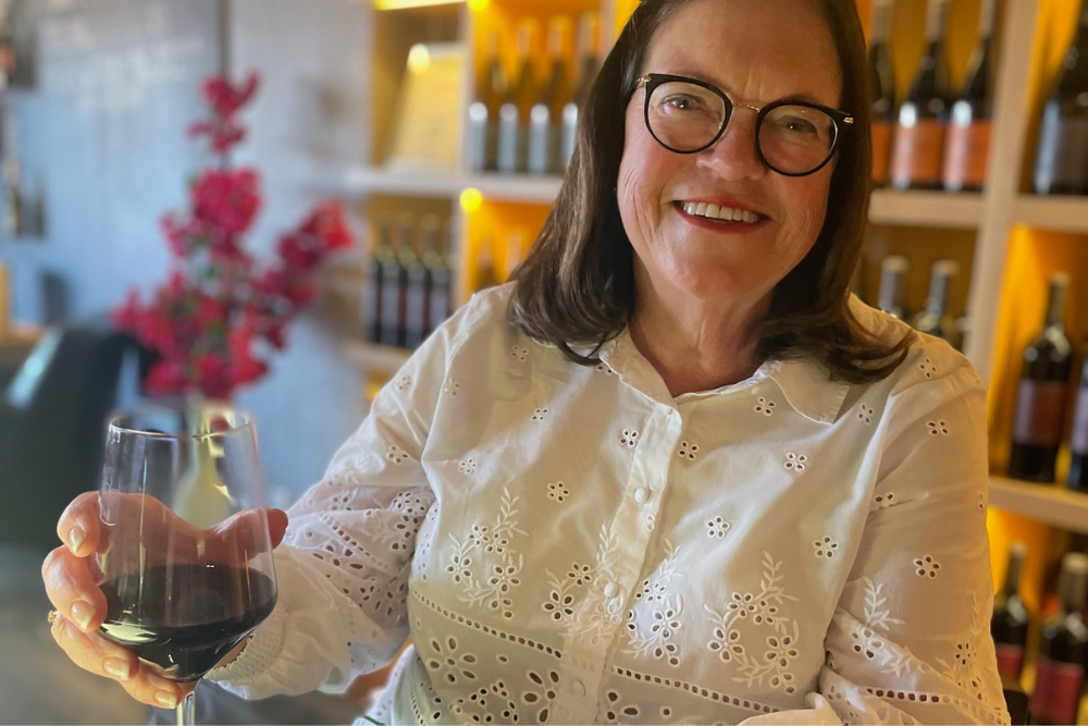 Ellen at a restaurant having a glass of wine